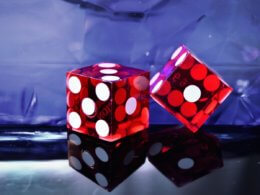 two red dices on a table