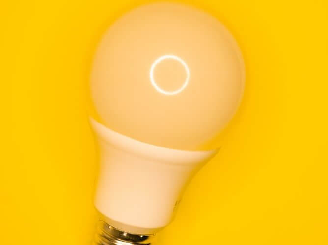 light bulb against yellow background